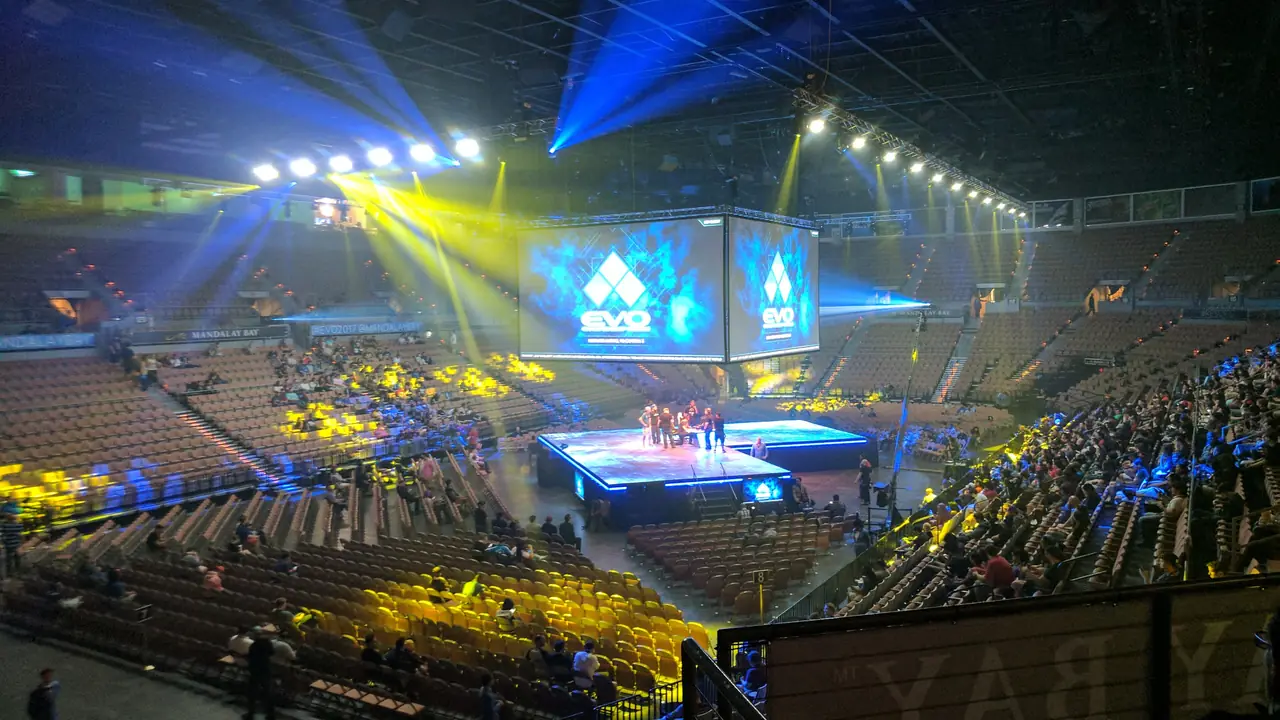 A packed arena with big screens and stage lights on the final day of Evo