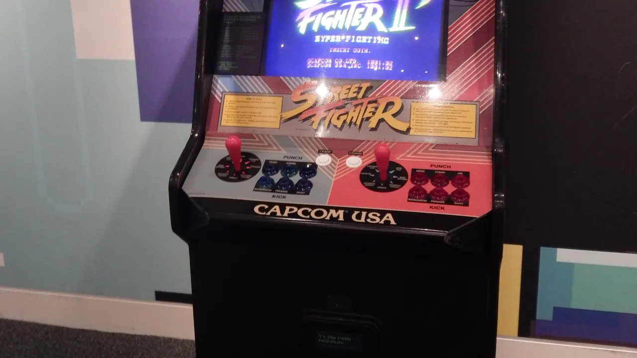 A Street Fighter II arcade cabinet on display in a museum